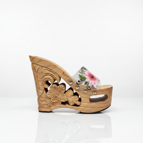 A single carved wooden wedge sandal with floral details, a pink flower print on the strap, and small gold-tone studs, shown on a plain white background.