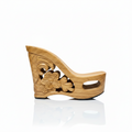 A single wooden wedge heel shoe with carved floral and scroll details on the side, shown against a plain white background.